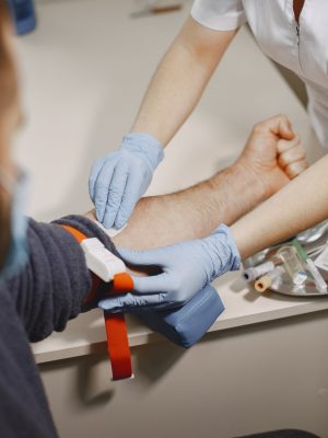 skillful-nurse-is-doing-blood-test-man-clinic-man-medical-mask_1157-48824